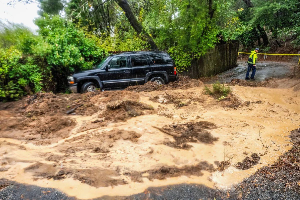 A firefighter evaluates a mudslide as heavy rains fall near Healdsburg in unincorporated Sonoma County, Calif., on Nov. 22, 2024. (Noah Berger/AP Photo)