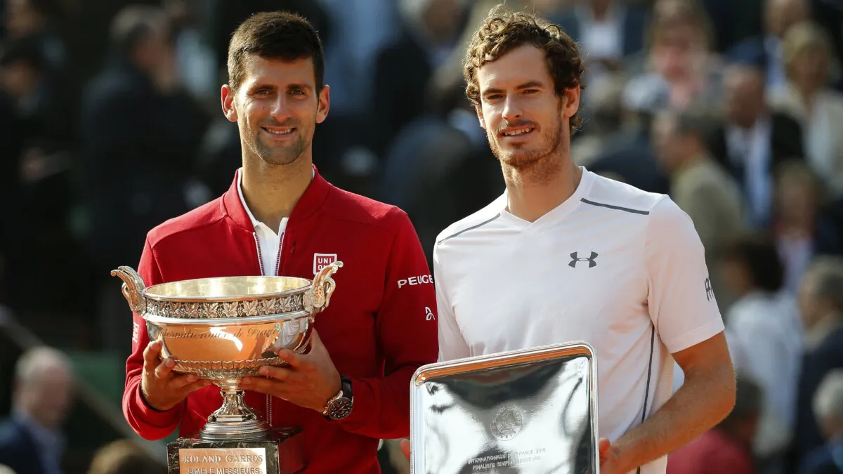 Serbia's Novak Djokovic (L) and Britain's Andy Murray holds their trophy after their final match of the French Open tennis tournament at the Roland Garros stadium in Paris on June 5, 2016. (Alastair Grant/AP Photo)