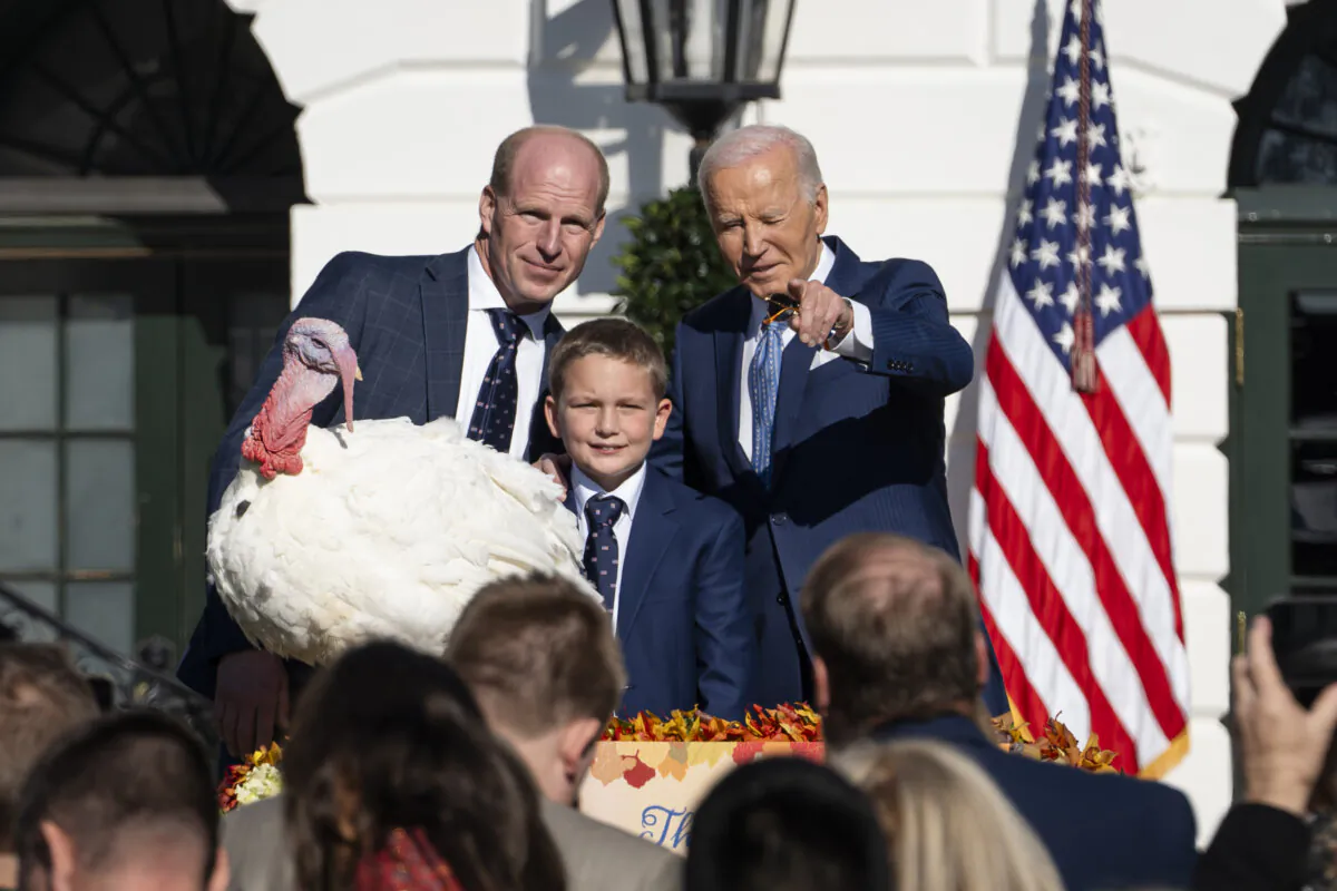 President Joe Biden (R) pardons Peach, the National Thanksgiving Turkey, joined by Chair of the National Turkey Federation John Zimmerman (L) and his son Grant at the South Lawn of the White House in Washington on Nov. 25, 2024. (Madalina Vasiliu/The Epoch Times)