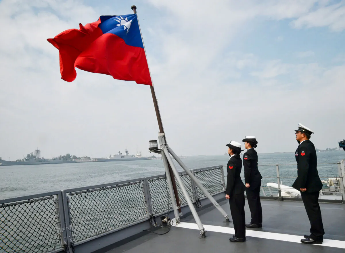 Taiwanese sailors salute the island's flag on the deck of the Panshih supply ship after taking part in annual drills, at the Tsoying naval base in Kaohsiung, Taiwan, on Jan. 31, 2018. (Mandy Cheng/AFP via Getty Images)