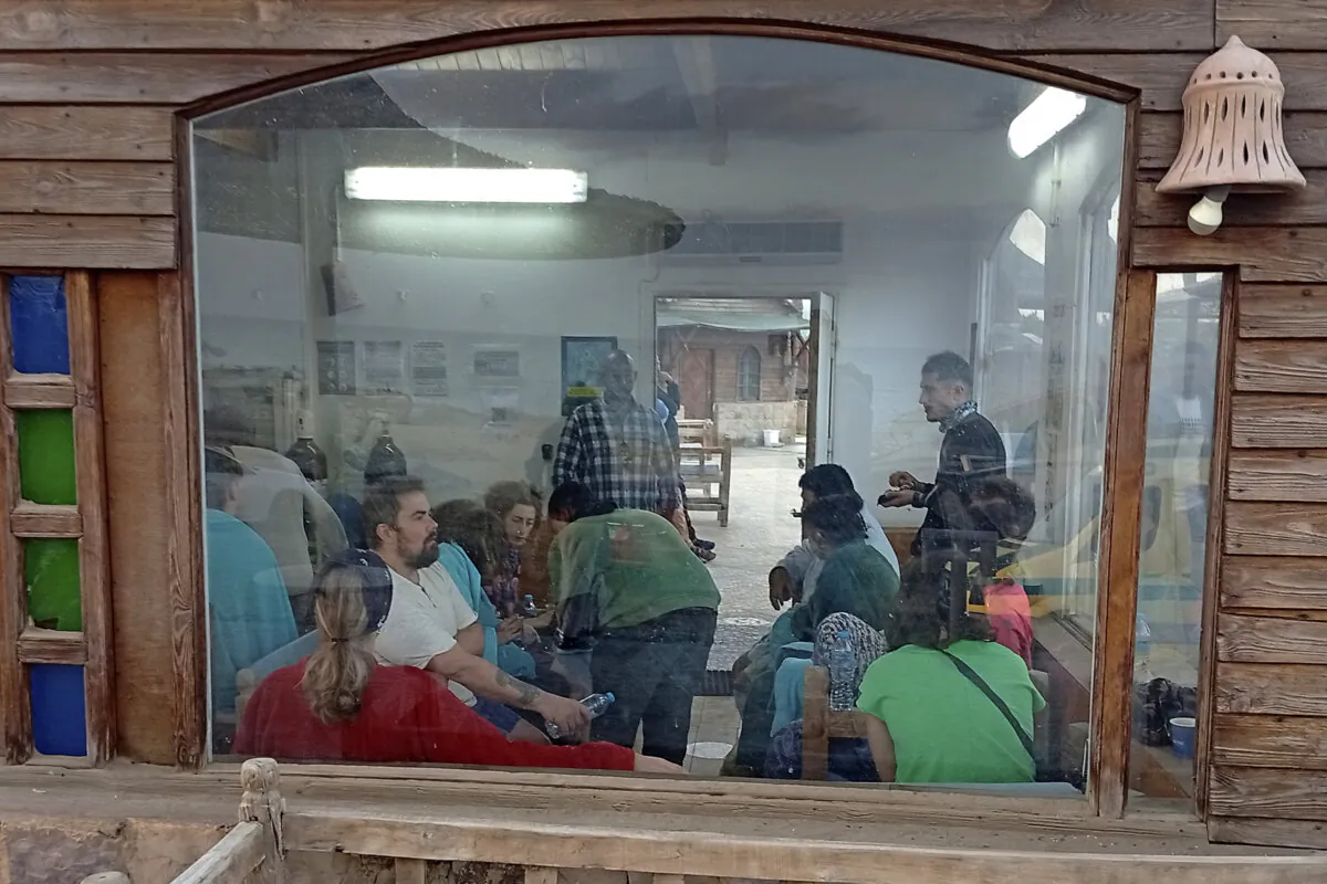 Survivors rest at a coffee shop in Marsa Alam, Egypt, on Nov. 25, 2024, after a tourist yacht sank in the Red Sea following warnings about rough seas. (AP Photo)