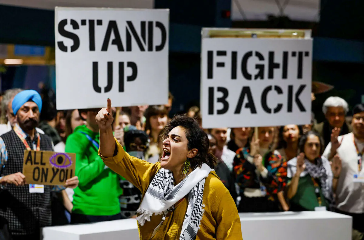 Activists shout slogans during a protest action at the COP29 U.N. climate change conference, in Baku, Azerbaijan, on Nov. 23, 2024. (Reuters/Maxim Shemetov)