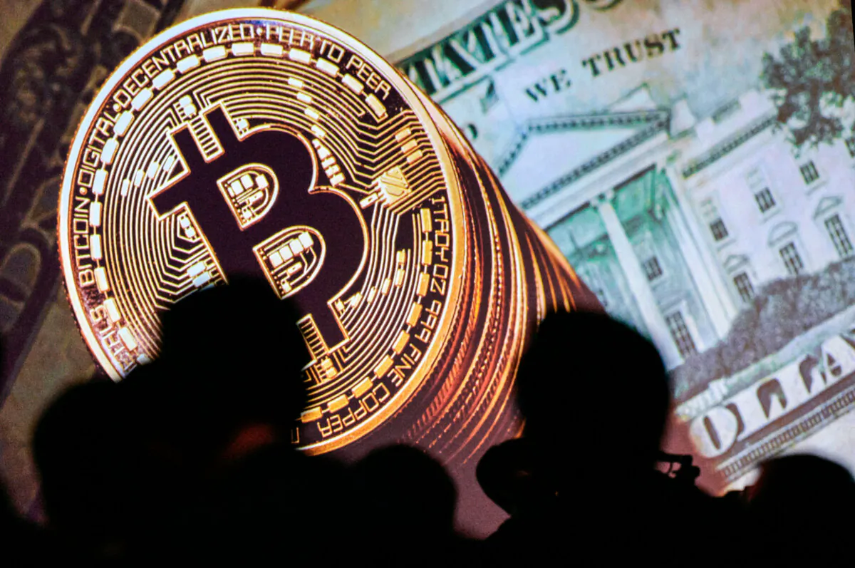An illustration representing bitcoin and U.S. currencies  displayed on a screen at the Interpol World Congress in Singapore on July 4, 2017. (Dominic Gwinn/AFP via Getty Images)