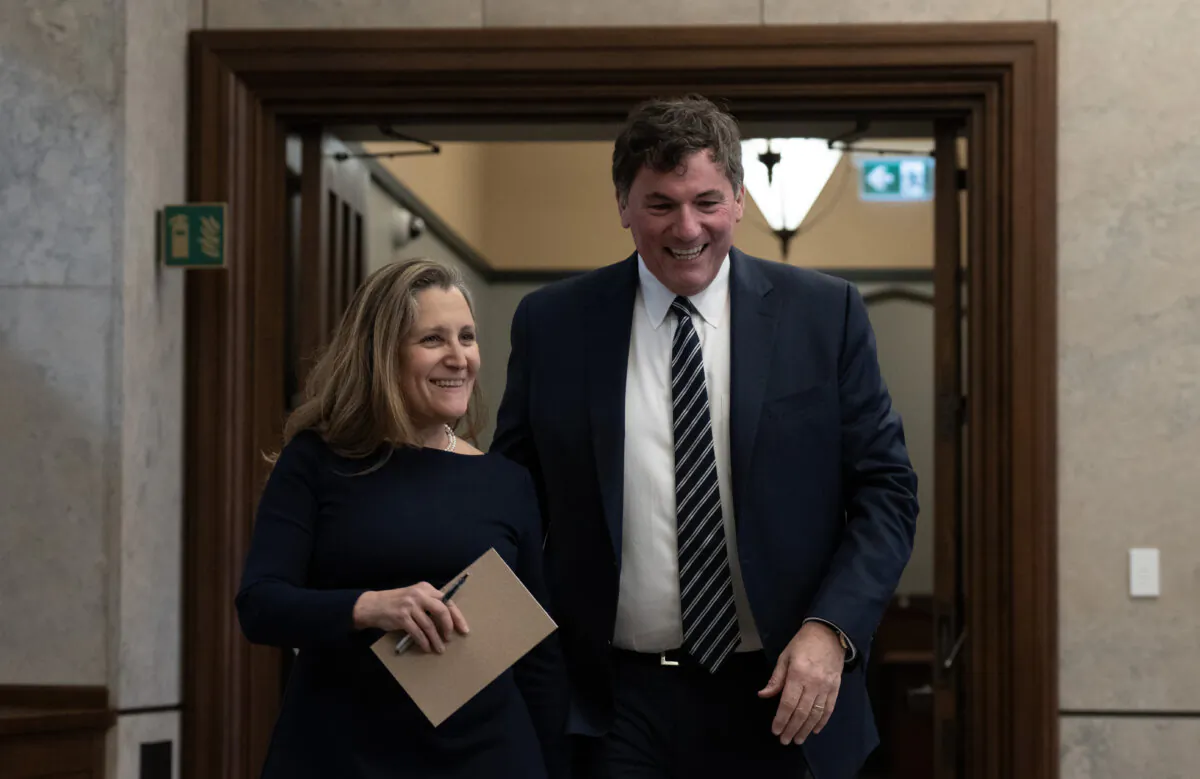 Deputy Prime Minister and Minister of Finance Chrystia Freeland walks with Minister of Public Safety, Democratic Institutions and Intergovernmental Affairs Dominic LeBlanc as they make their way to speak with reporters following cabinet meeting on Parliament Hill, in Ottawa, on Nov. 26, 2024. (The Canadian Press/Adrian Wyld)