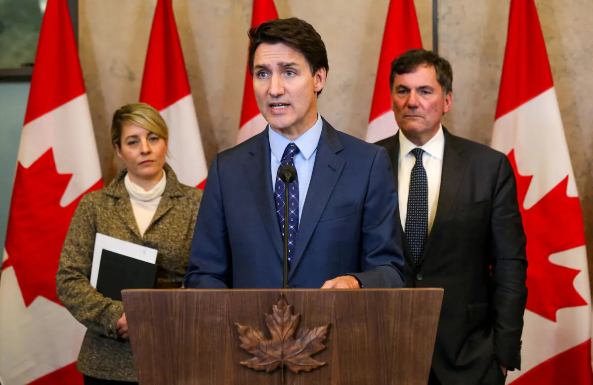 Canadian Prime Minister Justin Trudeau (C), with Foreign Minister Mélanie Joly (L) and Public Safety Minister Dominic LeBlanc, speaks during a press conference in Ottawa, on Oct. 14, 2024. (Dave Chan/AFP/Getty Images)