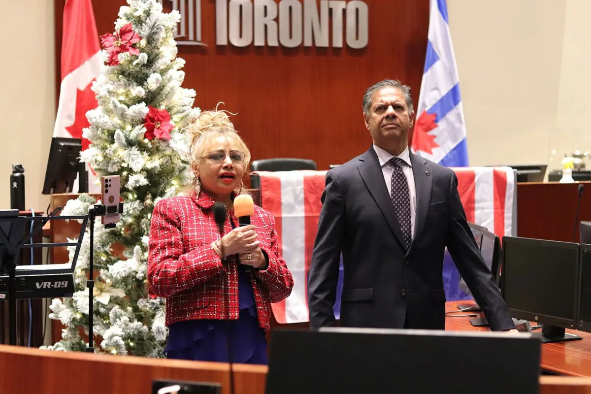 Molly Banerjei, alongside her husband, Jay, speaks during a Christian Heritage Month celebration at Toronto City Hall on Nov. 26, 2024. (Miguel Escobar/ClixterCanada)