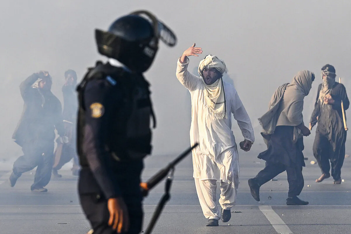 A supporter of Pakistan Tehreek-e-Insaf party gestures after tear gas was fired by the police to disperse the crowd during a protest to demand the release of former prime minister Imran Khan in Islamabad, Pakistan, on Nov. 26, 2024. (Aamir Qureshi/AFP via Getty Images)