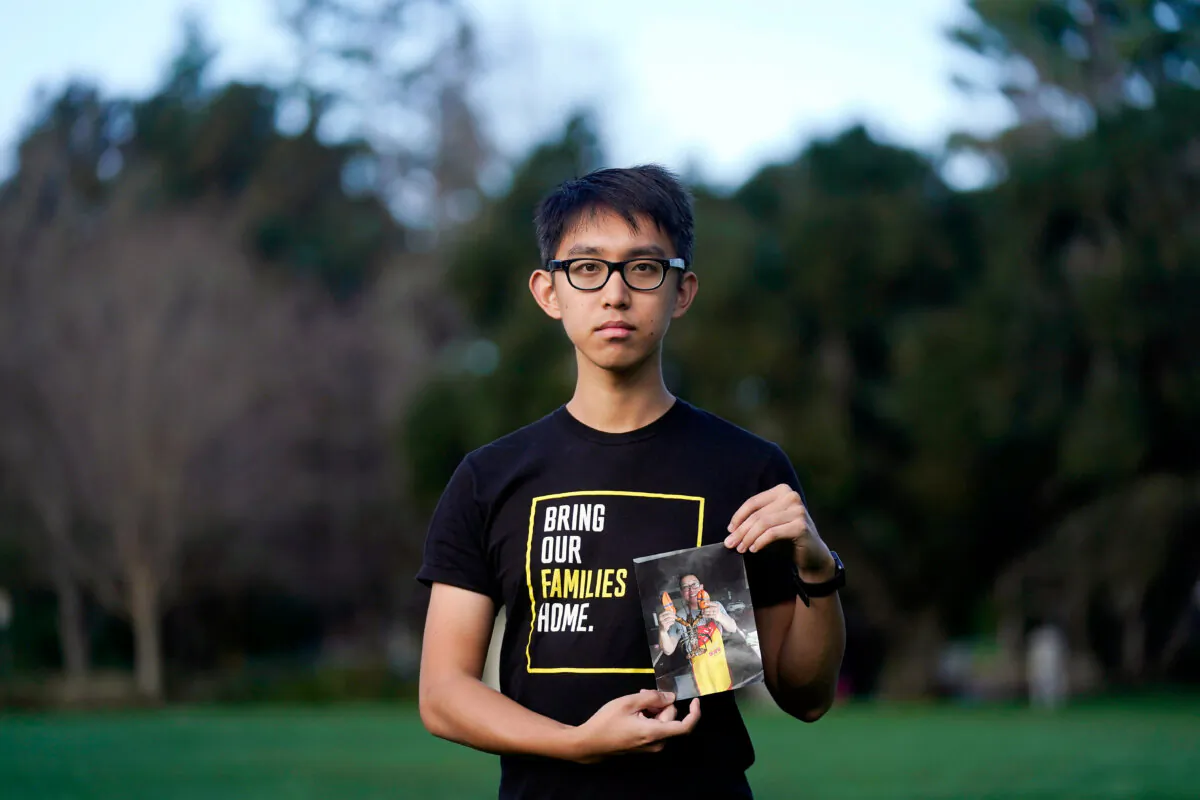 Harrison Li holds a photo of his father, Kai Li, in Palo Alto, Calif., on Jan. 23, 2024. (Jeff Chiu/AP Photo)