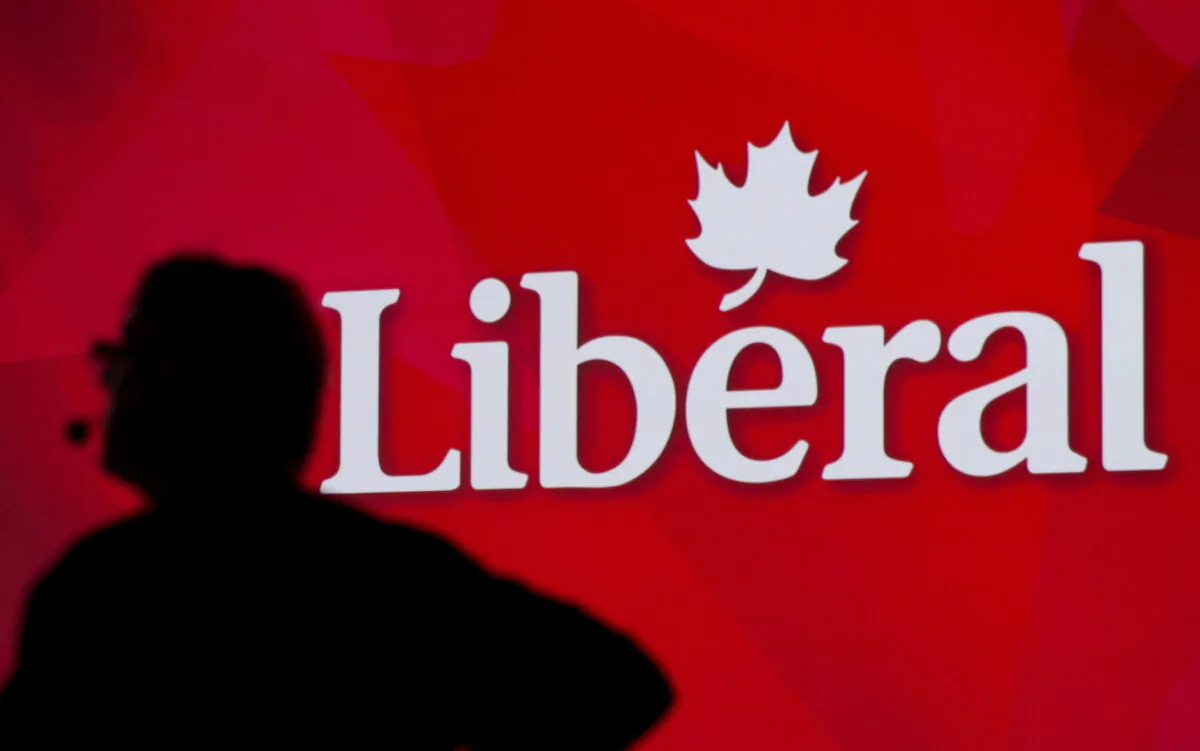 A Liberal Party of Canada logo is shown on a giant screen as a technician looks on during day one of the party's biennial convention in Montreal on Feb. 20, 2014. (The Canadian Press/Graham Hughes)