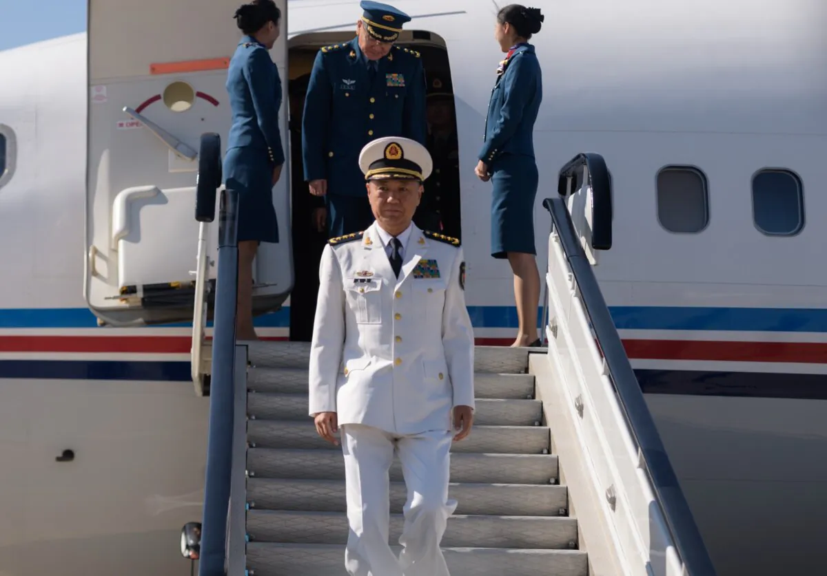 Adm. Miao Hua (C), China's director of the political affairs department of the Central Military Commission, disembarks his aircraft after arriving at Pyongyang International Airport in North Korea on Oct. 14, 2019. (Kim Won Jin/AFP via Getty Images)