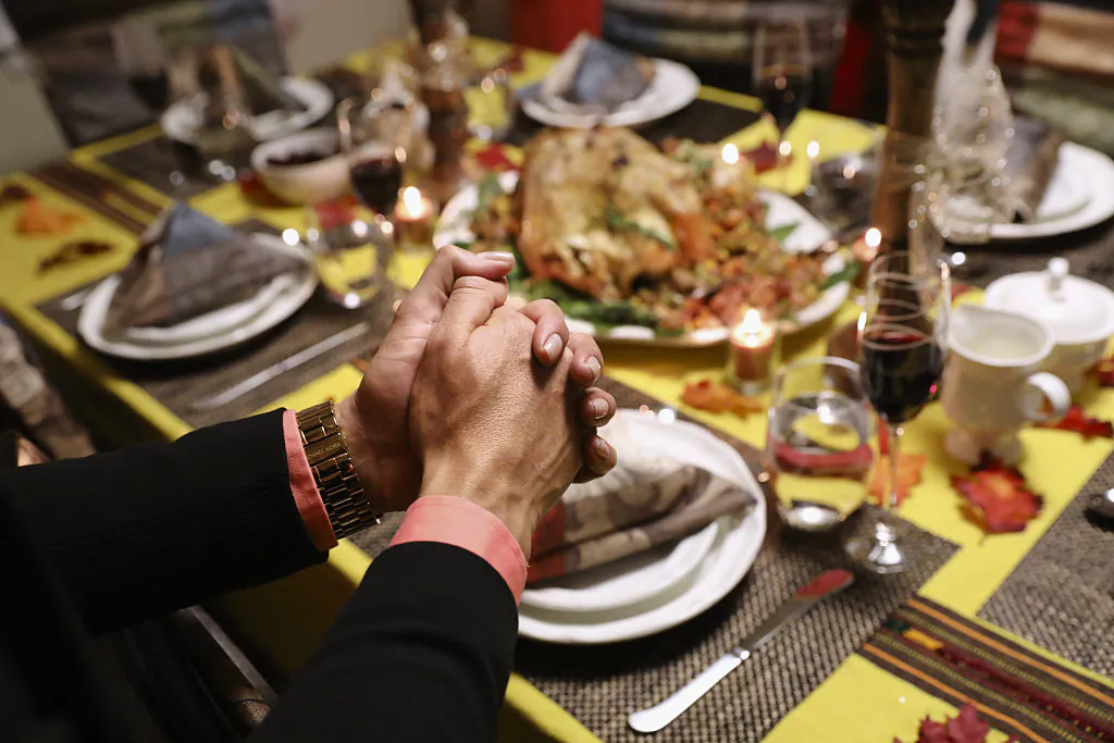 A family prays before Thanksgiving dinner in Stamford, Conn., on Nov. 24, 2016. (John Moore/Getty Images)