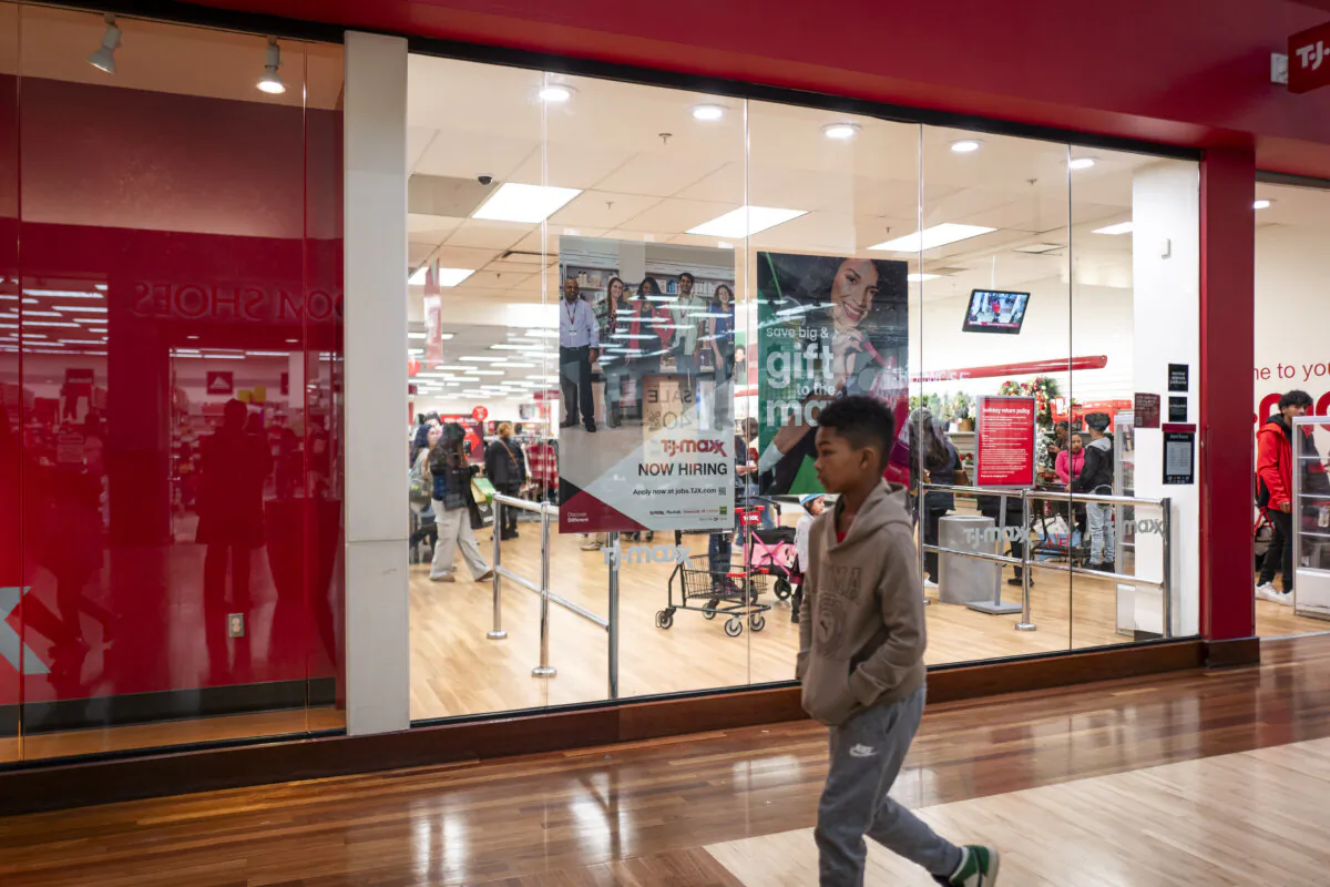 A boy walks past a hiring sign displayed during Black Friday at a mall in Hanover, Md., on Nov. 29, 2024. (Madalina Vasiliu/The Epoch Times)