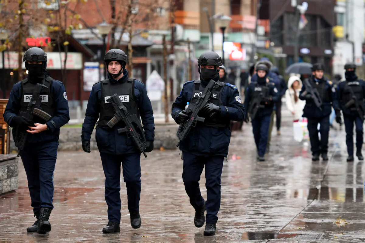 Kosovo Police officers patrol in the streets of Mitrovica, which is ethnically split between Serbs in the north and Albanians in the south, on Nov. 30, 2024. (Stringer/AFP via Getty Images)