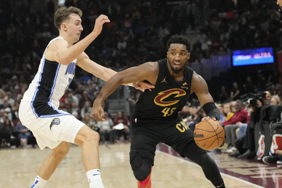 Cleveland Cavaliers guard Donovan Mitchell (45) drives past Orlando Magic forward Franz Wagner, left, in the first half of an NBA game in Cleveland, on Nov. 1, 2024. (Sue Ogrocki/AP Photo)