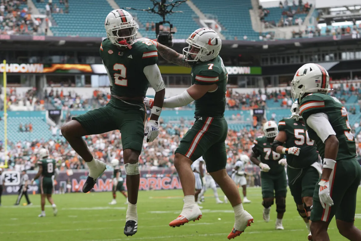 Miami wide receiver Xavier Restrepo (7) celebrates with wide receiver Isaiah Horton (2) after scoring a touchdown during the first half of an NCAA college football game against Duke, Saturday, Nov. 2, 2024, in Miami Gardens, Fla. (Lynne Sladky/AP Photo)