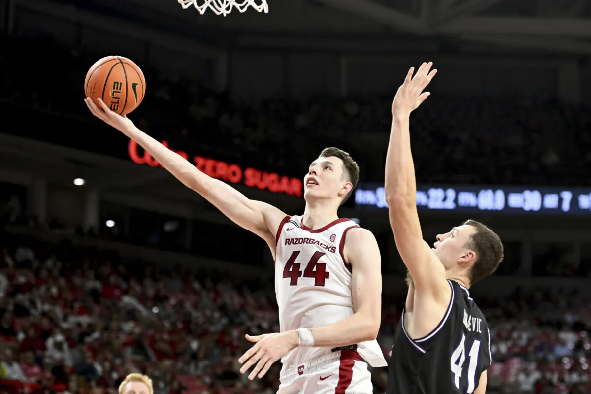Arkansas forward Zvonimir Ivisic (44) drives past Lipscomb forward Jacob Ognacevic (41) to score during the second half of an NCAA college basketball game Wednesday, Nov. 6, 2024, in Fayetteville, Ark. (Michael Woods/AP Photo)