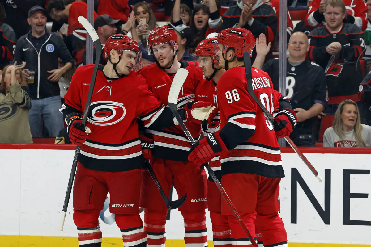 Carolina Hurricanes' Jack Roslovic (96) celebrates his goal with teammates Dmitry Orlov, left, Andrei Svechnikov, second left, and Sebastian Aho (20) during the second period of an NHL hockey game in Raleigh, N.C., on Nov. 7, 2024. (Karl B DeBlaker/AP Photo)