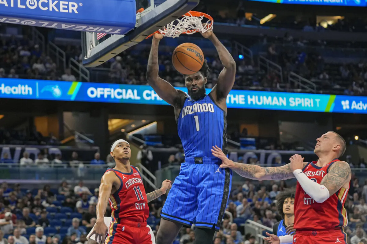 Orlando Magic forward Jonathan Isaac (1) dunks over New Orleans Pelicans guard Brandon Boston Jr. (11) and center Daniel Theis, right, during the first half of an NBA basketball game in Orlando, Fla, on Nov. 8, 2024. (John Raoux/AP Photo)