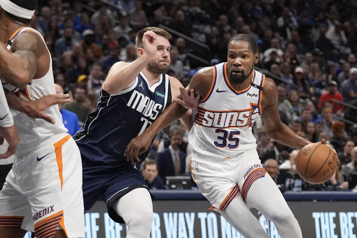 Phoenix Suns forward Kevin Durant (35) drives against Dallas Mavericks guard Luka Doncic (77) during the first half of an NBA basketball game Friday, Nov. 8, 2024, in Dallas. (LM Otero/AP Photo)