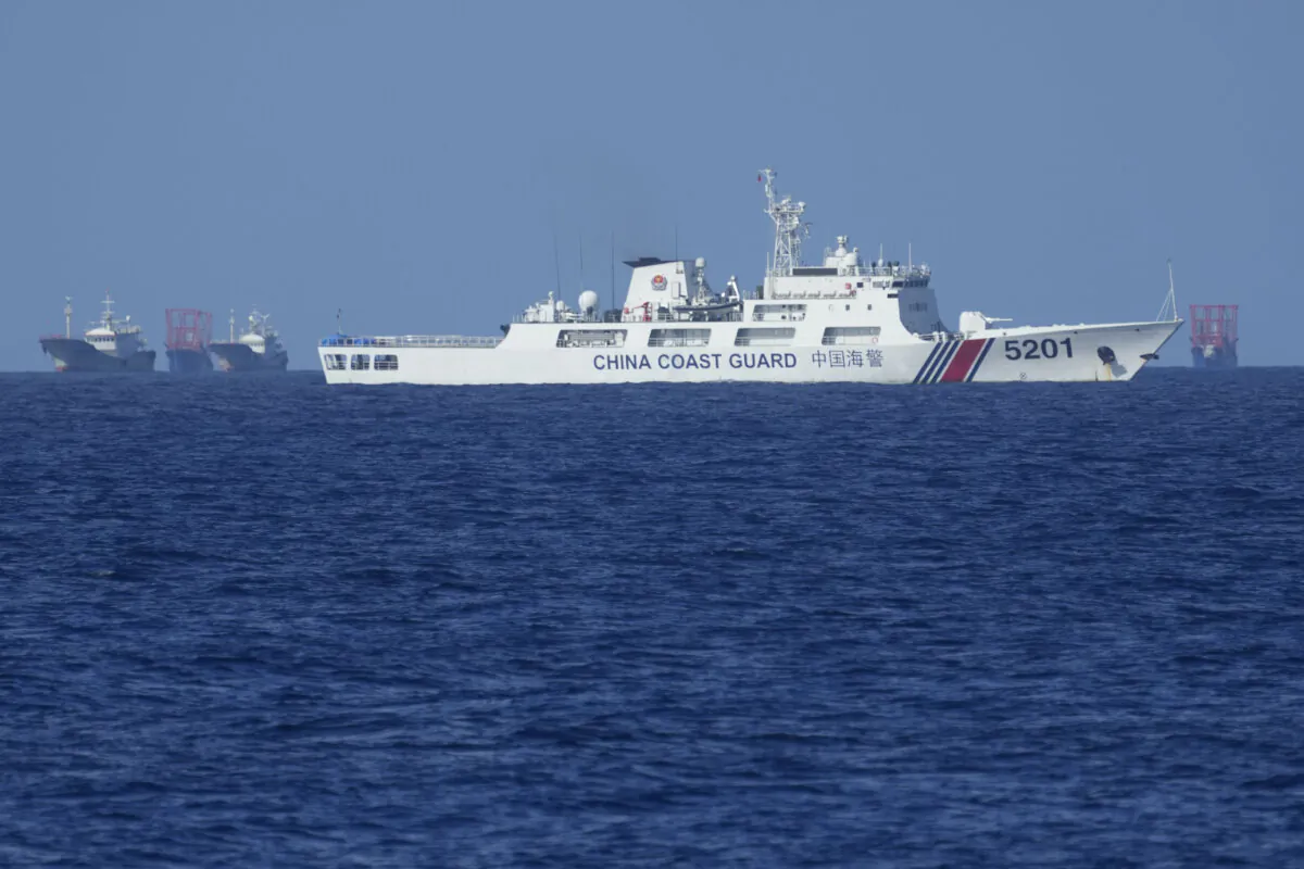 A Chinese coast guard vessel stays beside suspected Chinese militia ships near Thitu island, locally called Pag-asa island on Nov. 6, 2024. (Aaron Favila/AP Photo)