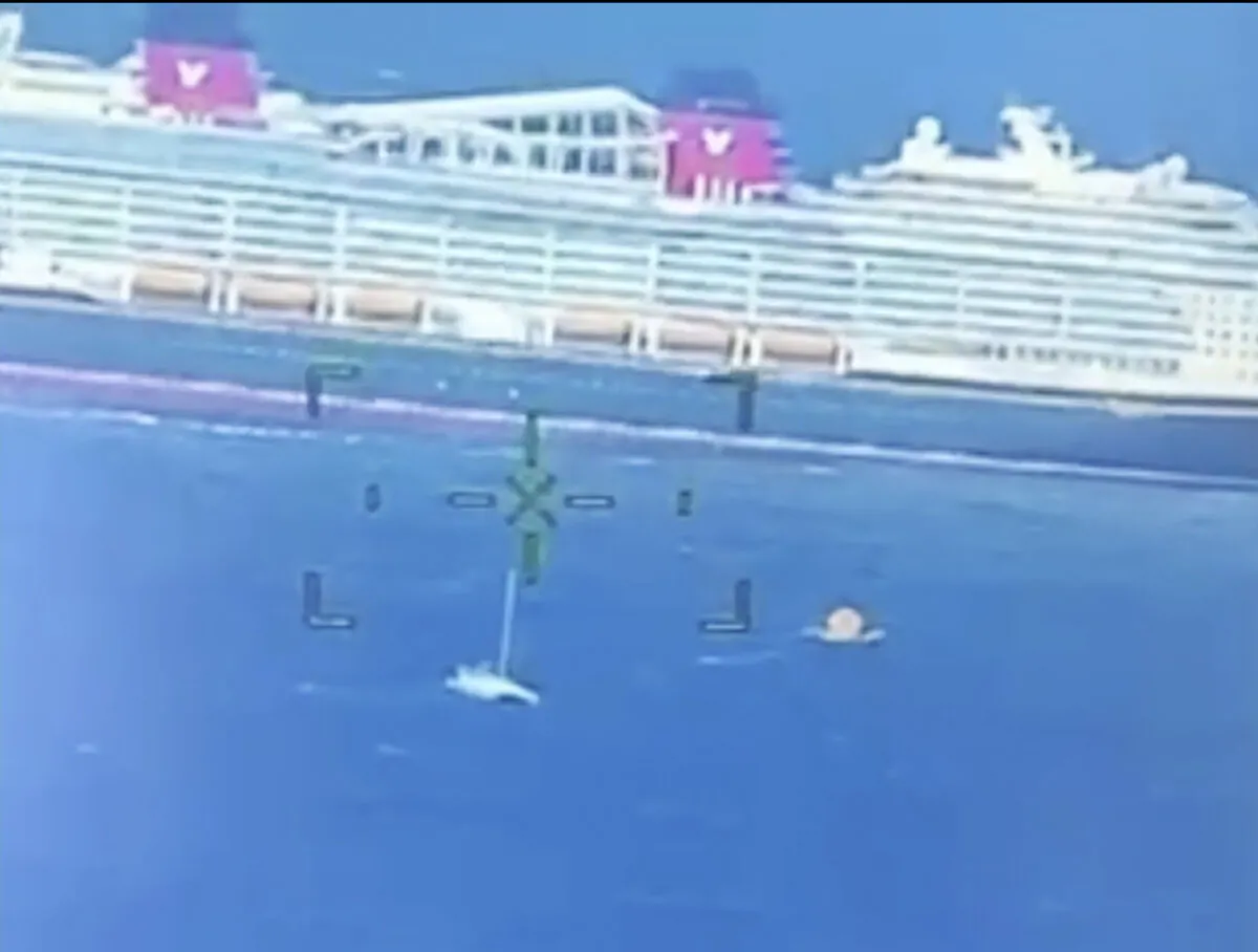 A cruise ship rescues people from a disabled catamaran that was taking on water hundreds of miles off the coast of Bermuda on Nov. 10, 2024. (U.S. Coast Guard via AP)