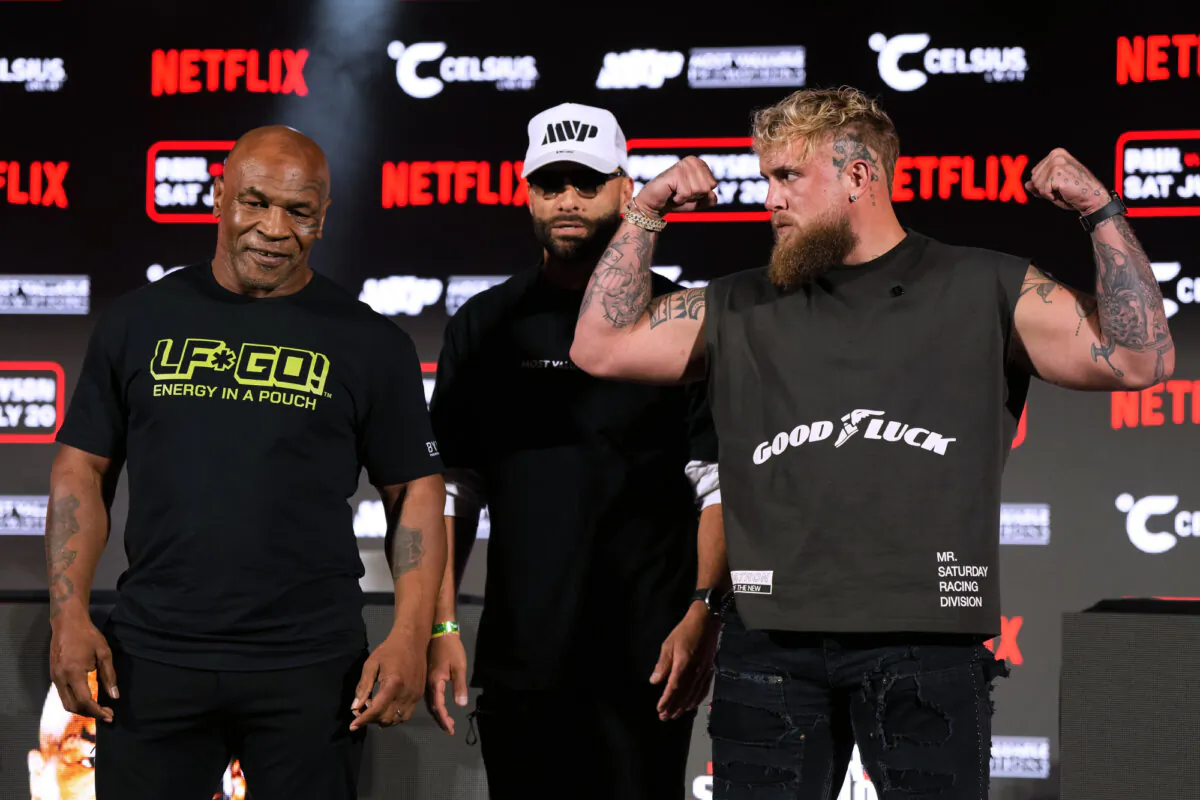 Mike Tyson (L) and Jake Paul (R) pose for photos during a news conference promoting their upcoming boxing bout, in Arlington, Texas, on May 16, 2024. (Sam Hodde/AP Photo)