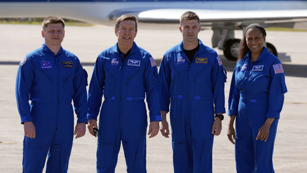The SpaceX crew of the Dragon spacecraft, from left, cosmonaut Alexander Grebenkin, pilot Michael Barratt, commander Matthew Dominick and mission specialist Jeanette Epps gather for a photo after arriving at the Kennedy Space Center in Cape Canaveral, Fla., Sunday, Feb. 25, 2024.  (John Raoux/AP Photo)
