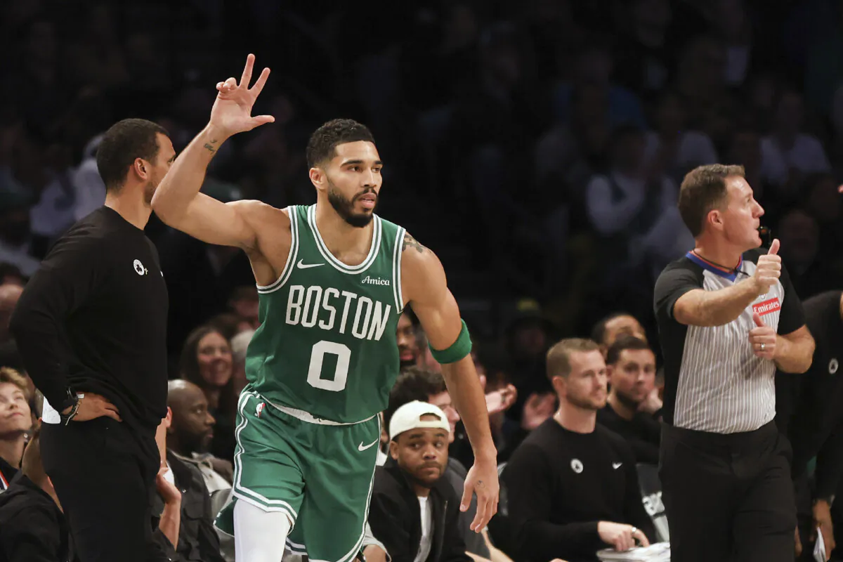 Boston Celtics' Jayson Tatum reacts after scoring a three-point basket in the first half of an NBA basketball game against the Brooklyn Nets, Wednesday, Nov. 13, 2024, in New York. (AP Photo/Heather Khalifa)