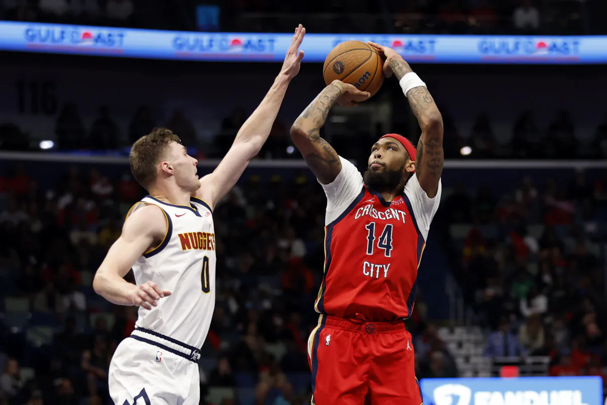New Orleans Pelicans forward Brandon Ingram (14) shoots a basket over Denver Nuggets guard Christian Braun (0) in the first half of an NBA basketball game in New Orleans, on Nov. 15, 2024. (Tyler Kaufman/AP Photo)