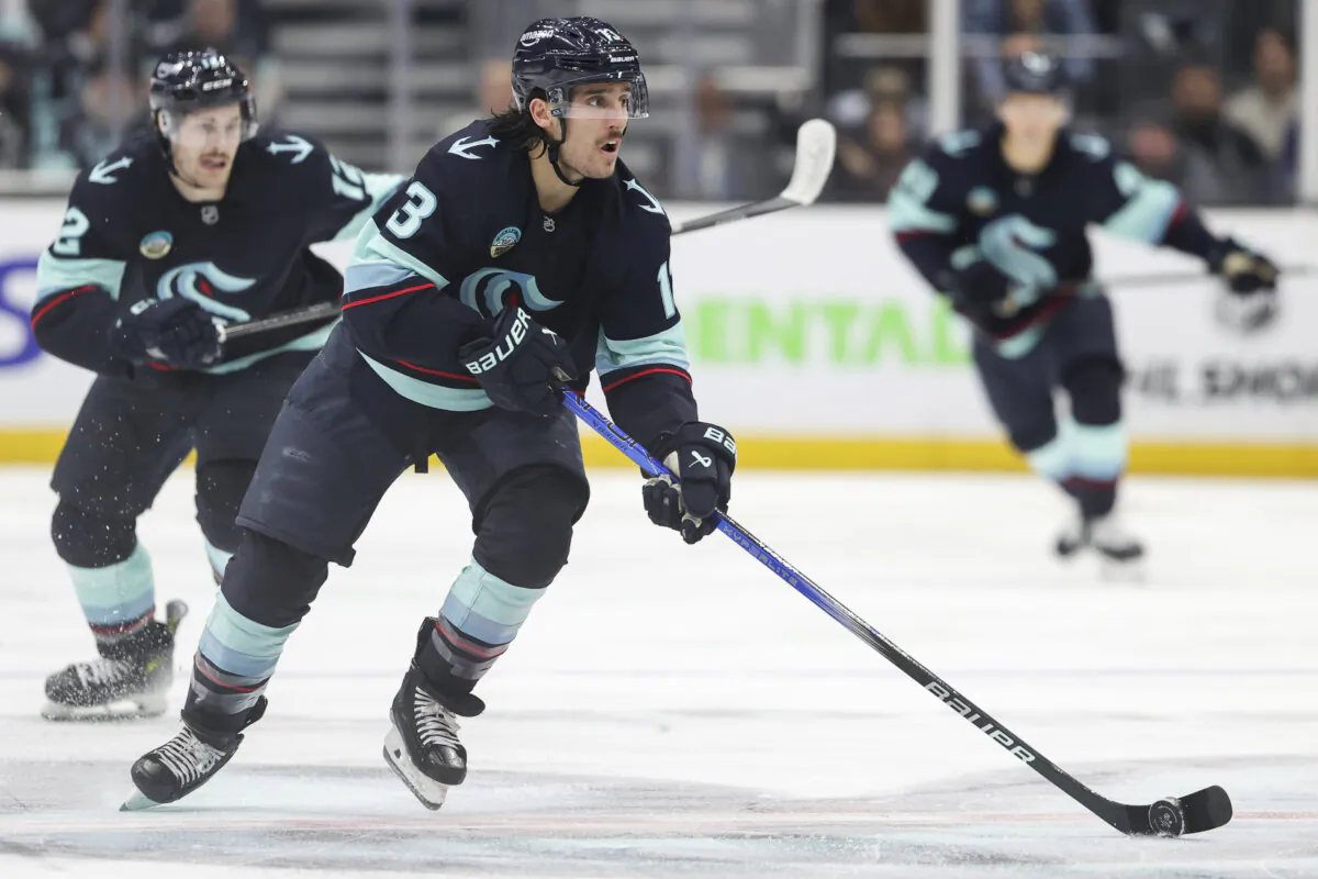Seattle Kraken left wing Brandon Tanev (13) moves the puck against the New York Islanders during the second period of an NHL hockey game, Saturday, Nov. 16, 2024, in Seattle. (Rio Giancarlo/AP Photo)