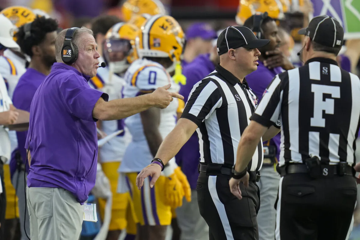 LSU head coach Brian Kelly, left, makes a point with officials during the first half of an NCAA college football game against Florida, Saturday, Nov. 16, 2024, in Gainesville, Fla. (John Raoux/AP Photo)