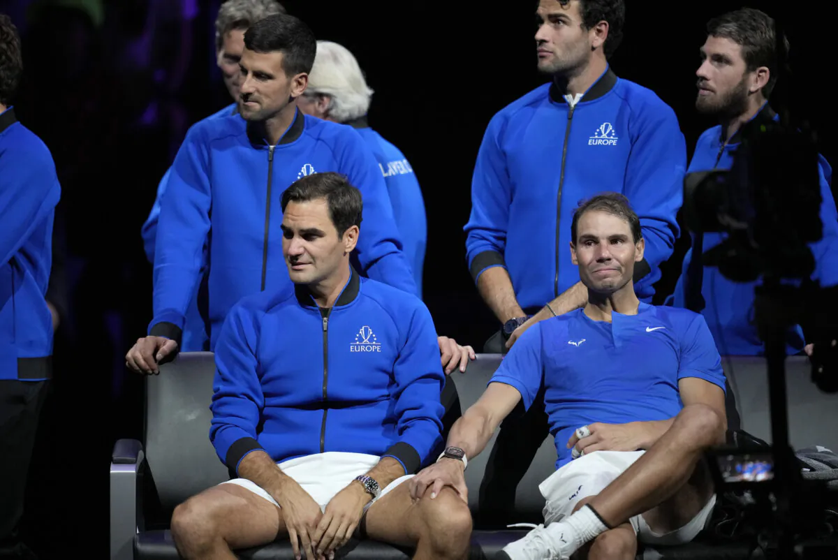 An emotional Roger Federer of Team Europe is consoled by his playing partner Rafael Nadal after their Laver Cup doubles match against Team World's Jack Sock and Frances Tiafoe at the O2 arena in London on Sept. 23, 2022. (Kin Cheung/AP Photo)