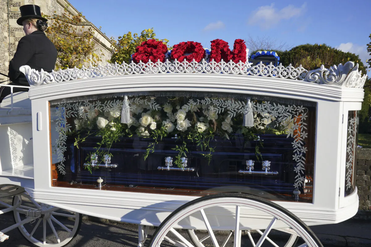 A horse-drawn carriage carrying the coffin of Liam Payne arrives for the funeral service of the One Direction singer at St Mary's Church in Amersham, Buckinghamshire, England, Wednesday Nov. 20, 2024. (Jonathan Brady/PA via AP)