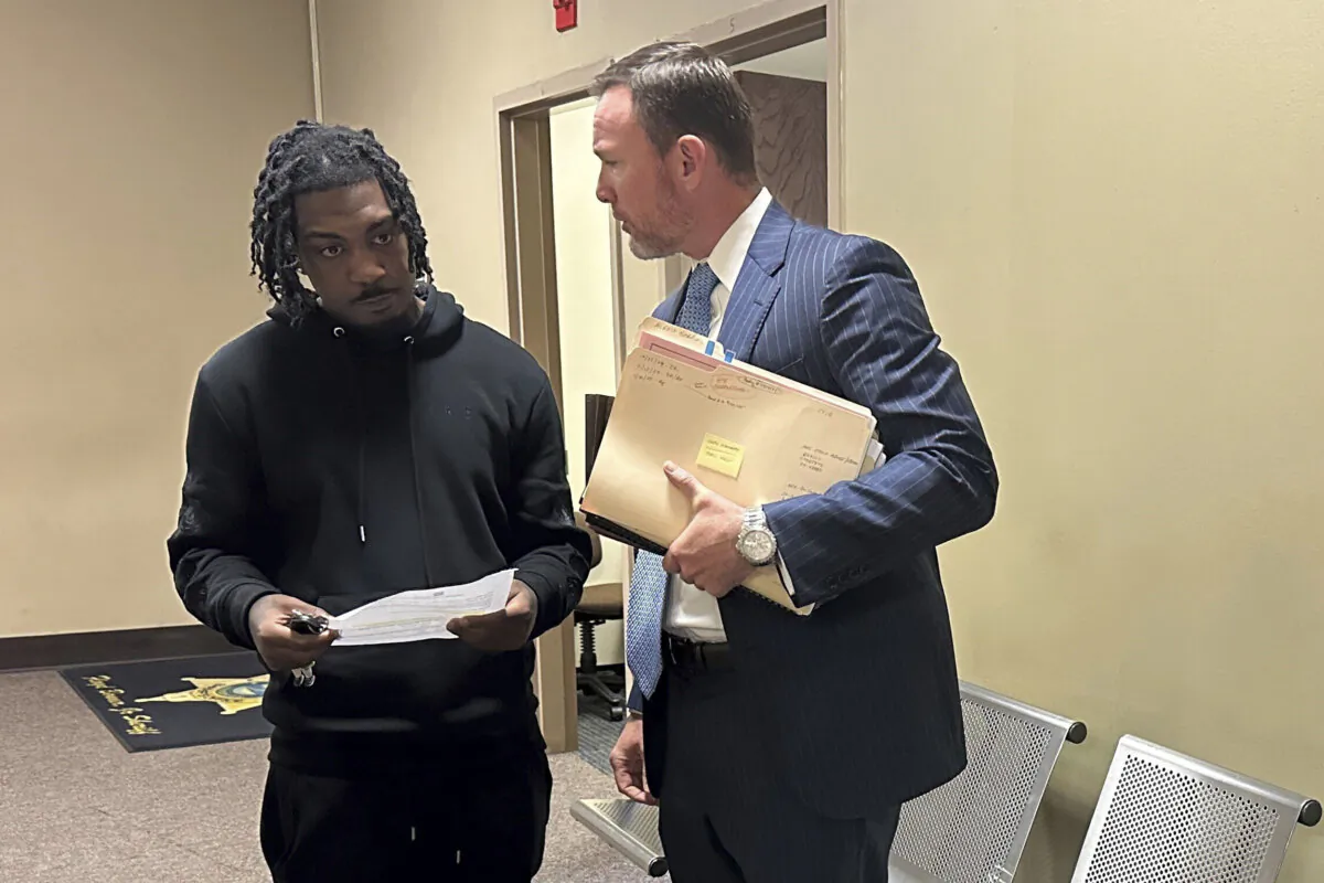 Jermarcus Johnson, left, speaks with his lawyer Josh Corman after Johnson was sentenced to probation for his role after the 2021 fatal shooting of Young Dolph on Friday, Nov. 22, 2024, in Memphis, Tenn. (Adrian Sainz/AP Photo)