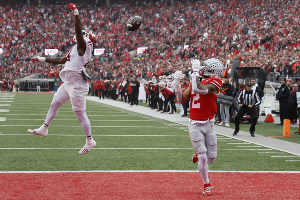 Ohio State receiver Emeka Egbuka, right, catches a touchdown pass thrown over Indiana defensive lineman Lanell Carr during the first half of an NCAA college football game Saturday, Nov. 23, 2024, in Columbus, Ohio. (Jay LaPrete/AP Photo)
