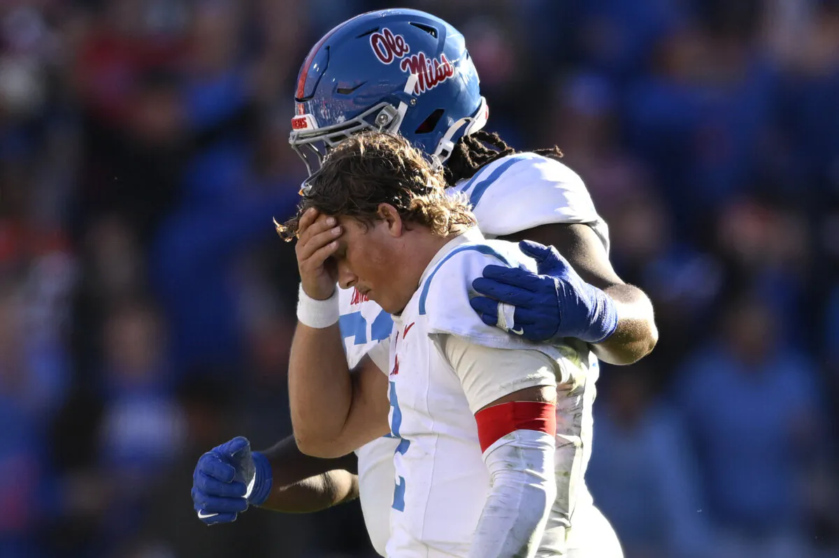 Mississippi quarterback Jaxson Dart (2) is consoled by offensive lineman Diego Pounds, rear, after throwing an interception late in the second half of an NCAA college football game against Florida in Gainesville, Fla., on Nov. 23, 2024. (Phelan M. Ebenhack/AP Photo)