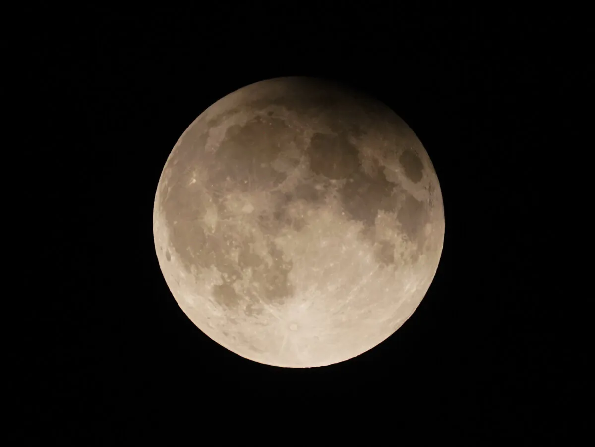 A supermoon with a partial lunar eclipse rises over Lake Michigan in Chicago on Sept. 17, 2024. (Kiichiro Sato/AP Photo)