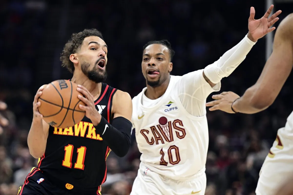 Atlanta Hawks guard Trae Young drives on Cleveland Cavaliers guard Darius Garland in the first half of an NBA basketball game, Wednesday, Nov. 27, 2024, in Cleveland. (David Dermer/AP Photo)