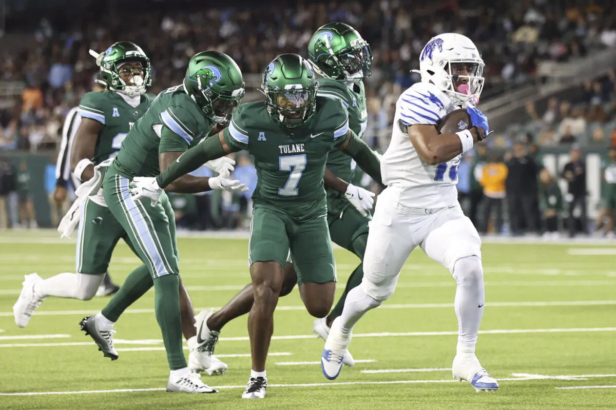 Memphis running back Greg Desrosiers Jr., right, takes a reception into the end zone against Tulane defenders during the first half of an NCAA college football game in New Orleans, Thursday, Nov. 28, 2024. (Peter Forest/AP Photo)