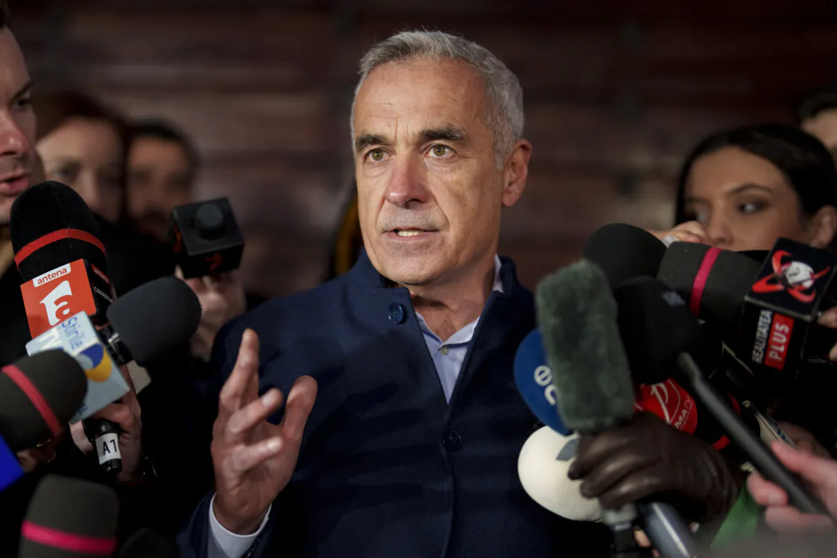 Calin Georgescu, running as an independent candidate for president of Romania, gestures while speaking to reporters in Izvorani, Romania, after making it to the Dec. 8 election runoff, on Nov. 26, 2024. (AP Photo/Vadim Ghirda)