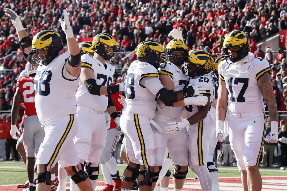 Michigan players celebrate their touchdown against Ohio State during the first half of an NCAA college football game Saturday, Nov. 30, 2024, in Columbus, Ohio. (Jay LaPrete/AP Photo)