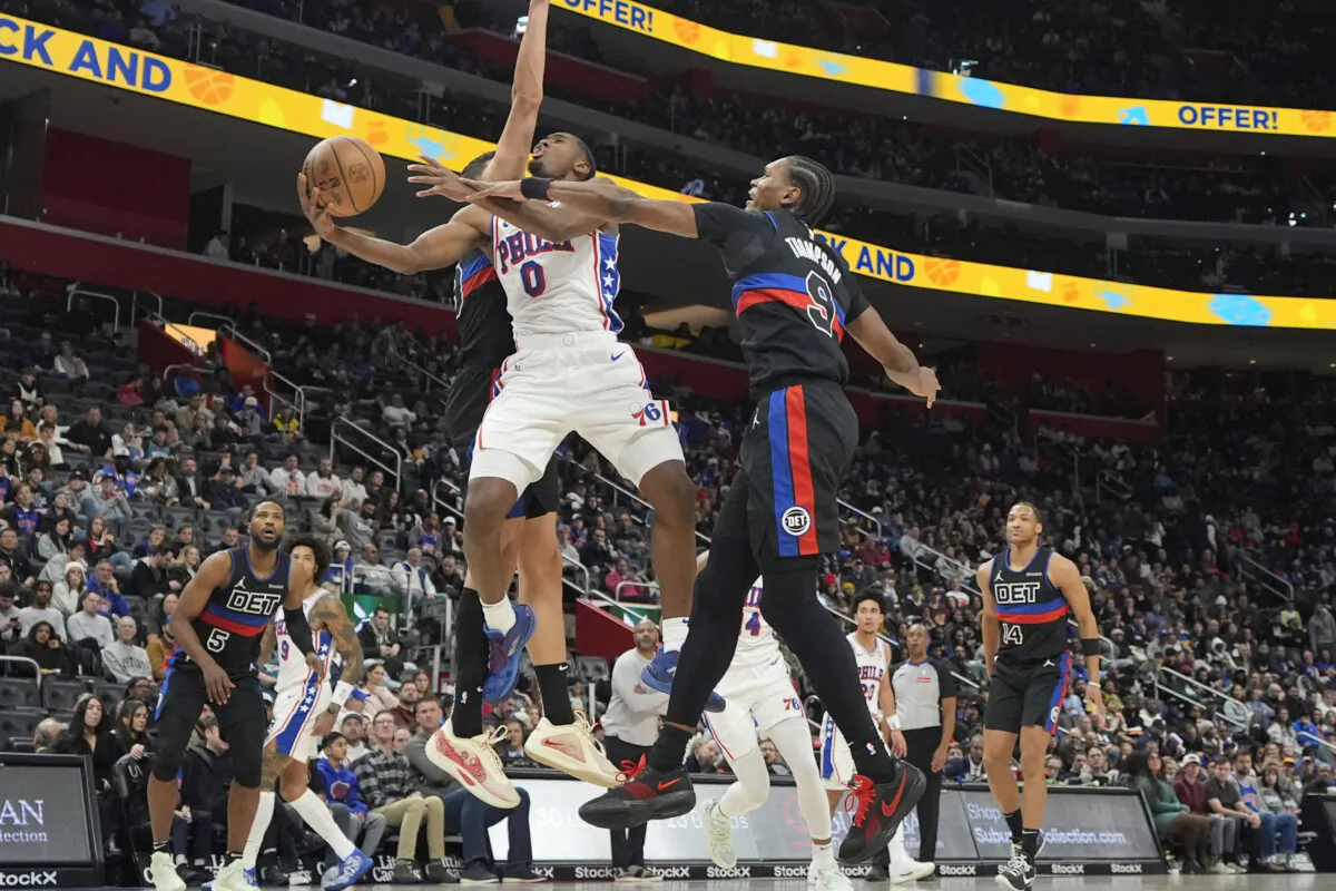Philadelphia 76ers guard Tyrese Maxey (0) attempts a layup as Detroit Pistons forward Ausar Thompson (9) defends during the second half of an NBA basketball game, Saturday, Nov. 30, 2024, in Detroit. (Carlos Osorio/AP Photo)