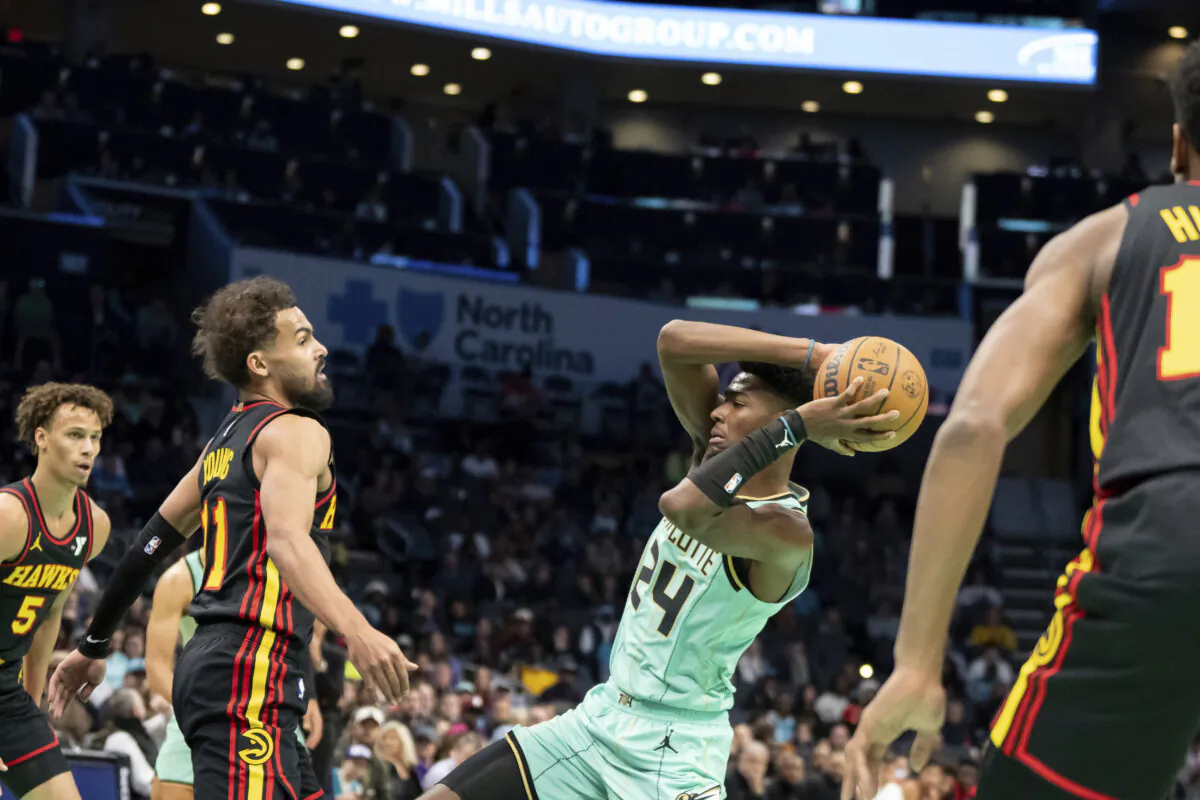 Charlotte Hornets forward Brandon Miller (24) looks to pass the ball away from Atlanta Hawks guard Trae Young (11) during the first half of an NBA basketball game, Saturday, Nov. 30, 2024, in Charlotte, N.C. (Matt Kelley/AP Photo)