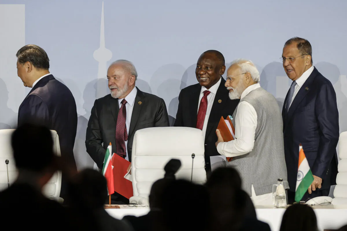 (L–R) Chinese leader Xi Jinping, Brazilian President Luiz Inácio Lula da Silva, South African President Cyril Ramaphosa, Indian Prime Minister Narendra Modi, and Russian Foreign Minister Sergei Lavrov gesture as they attend the 2023 BRICS summit at the Sandton Convention Centre in Johannesburg on Aug. 24, 2023. (Gianluigi Guercia/AFP via Getty Images)