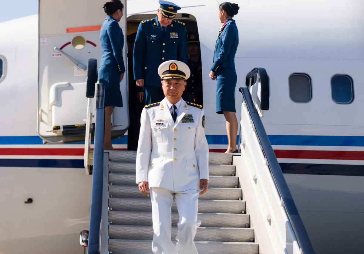 Adm. Miao Hua (C), China's director of the political affairs department of the Central Military Commission, disembarks his aircraft after arriving at Pyongyang International Airport in North Korea on Oct. 14, 2019. (Kim Won Jin/AFP via Getty Images)