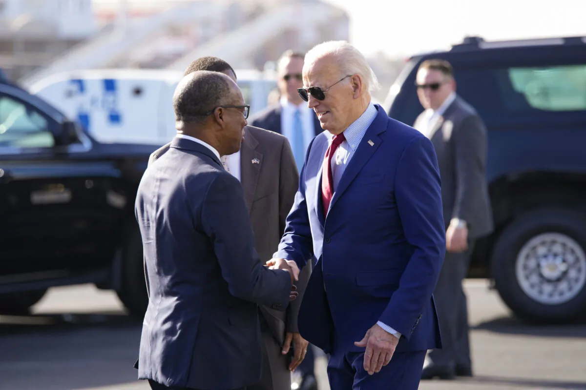 President Joe Biden is greeted by Cape Verdean Prime Minister Ulisses Correia e Silva at Amilcar Cabral international airport on Sal island, Cape Verde, en route to Angola as he makes his long-promised visit to Africa, on Dec. 2, 2024. (AP Photo/Ben Curtis)