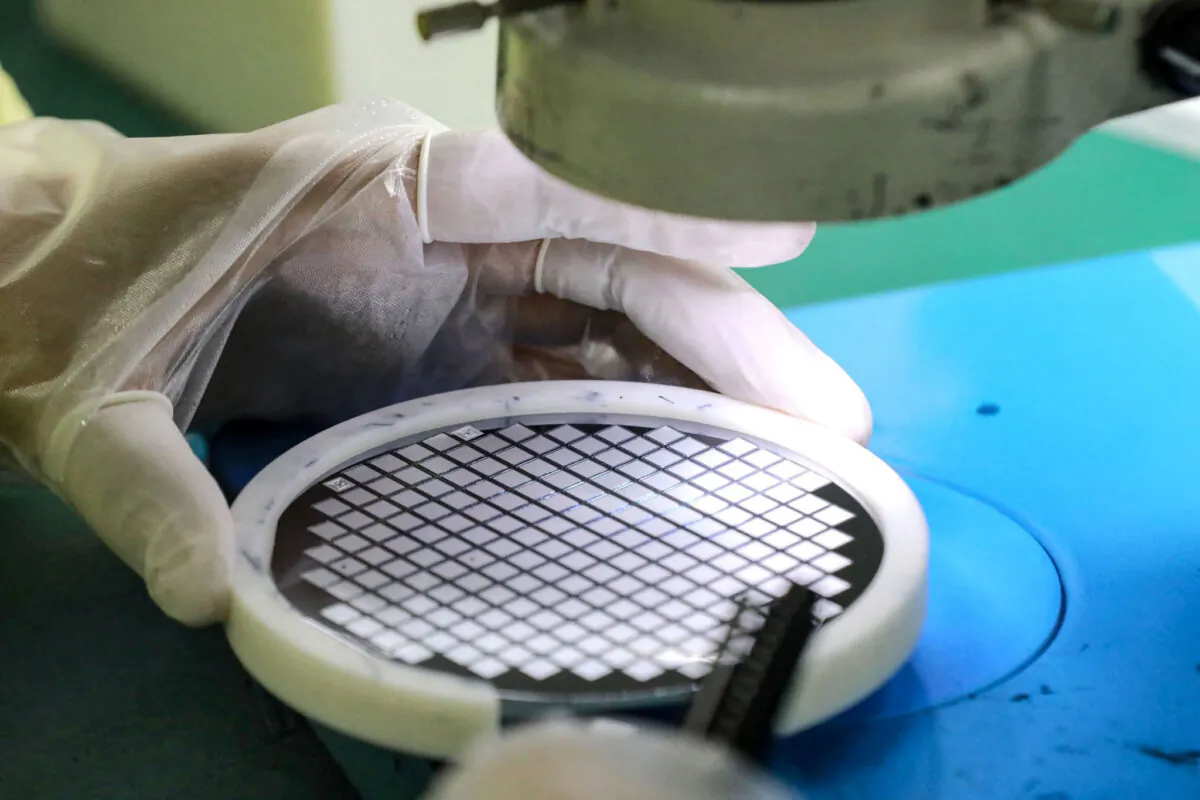 An employee makes a chip at a factory of Jiejie Semiconductor Company in Nantong, Jiangsu Province, China, on March 17, 2021. (STR/AFP via Getty Images)