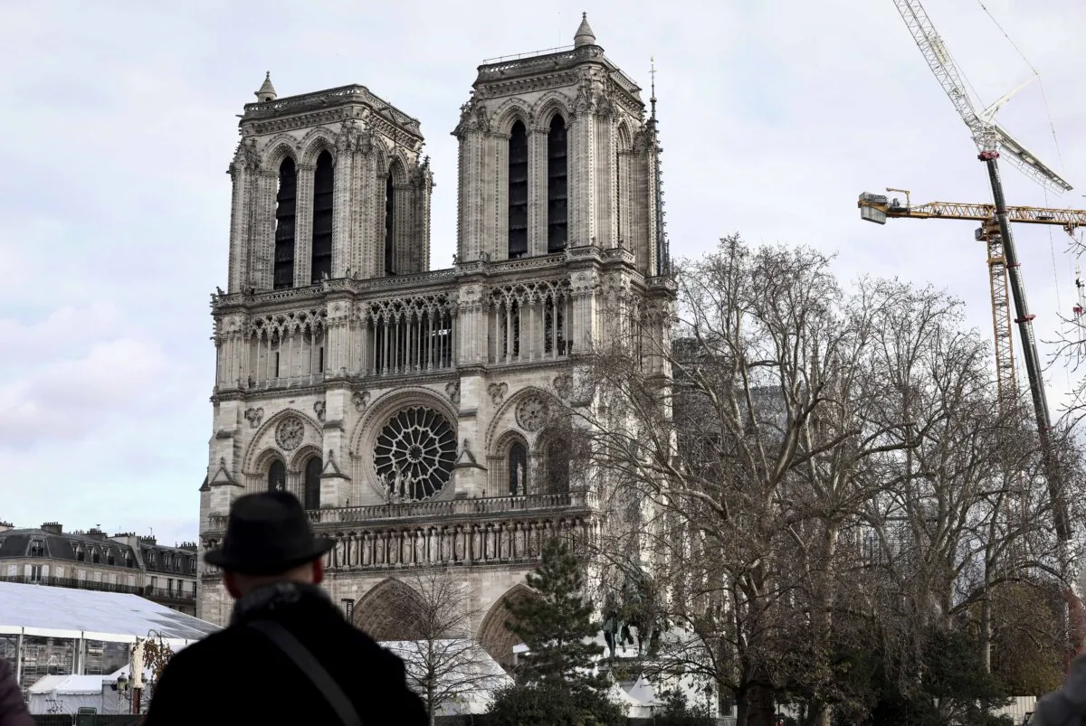 A man stands in front of Notre-Dame de Paris cathedral a few days before its reopening, in Paris on Dec. 2, 2024. (Behrouz Mehri/AFP via Getty Images)