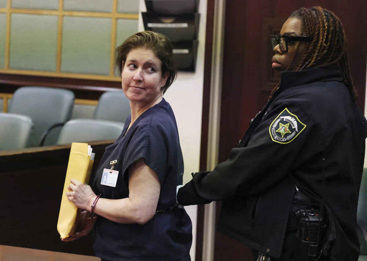 Sarah Boone is led off in handcuffs as she glances back at supporters in a courtroom of the Orange County Courthouse in Orlando, Fla., on Dec. 2, 2024. (Stephen M. Dowell/Orlando Sentinel via AP)