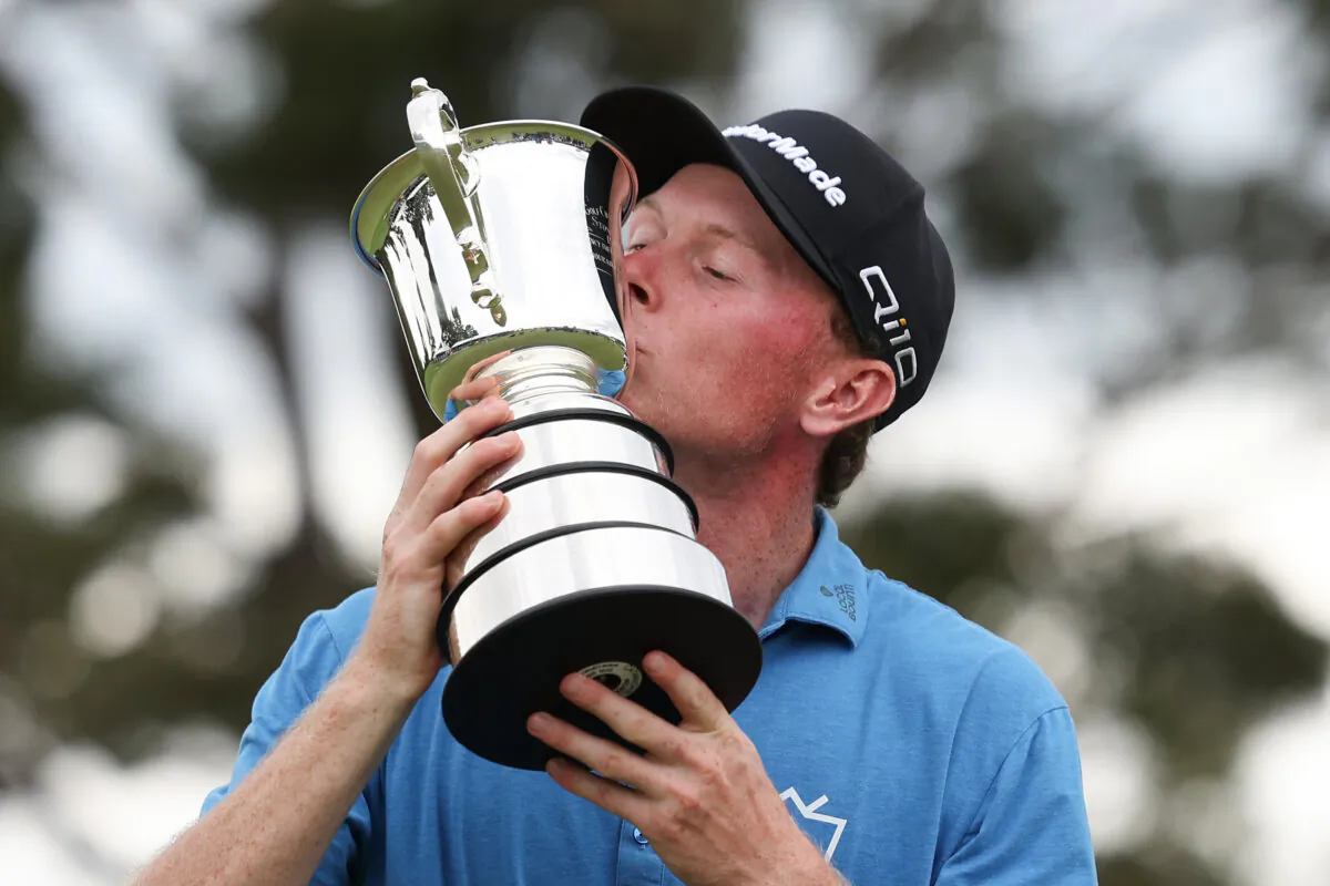 Ryggs Johnston of the United States kisses the Stonehaven Cup on day four of the ISPS Handa Australian Open 2024 at Kingston Heath Golf Club in Melbourne, Australia on Dec. 1, 2024. (Morgan Hancock/Getty Images)